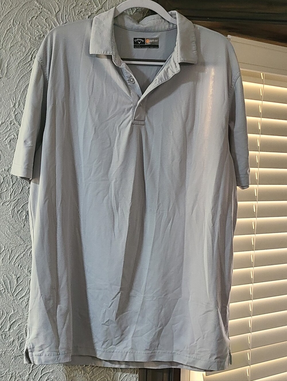 Grey Callaway polo shirt featuring subtle striped fabric  performance technology